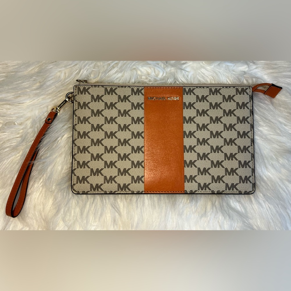 Michael Kors, orange and tan clutch with zipper. In great condition. LIKE NEW!!